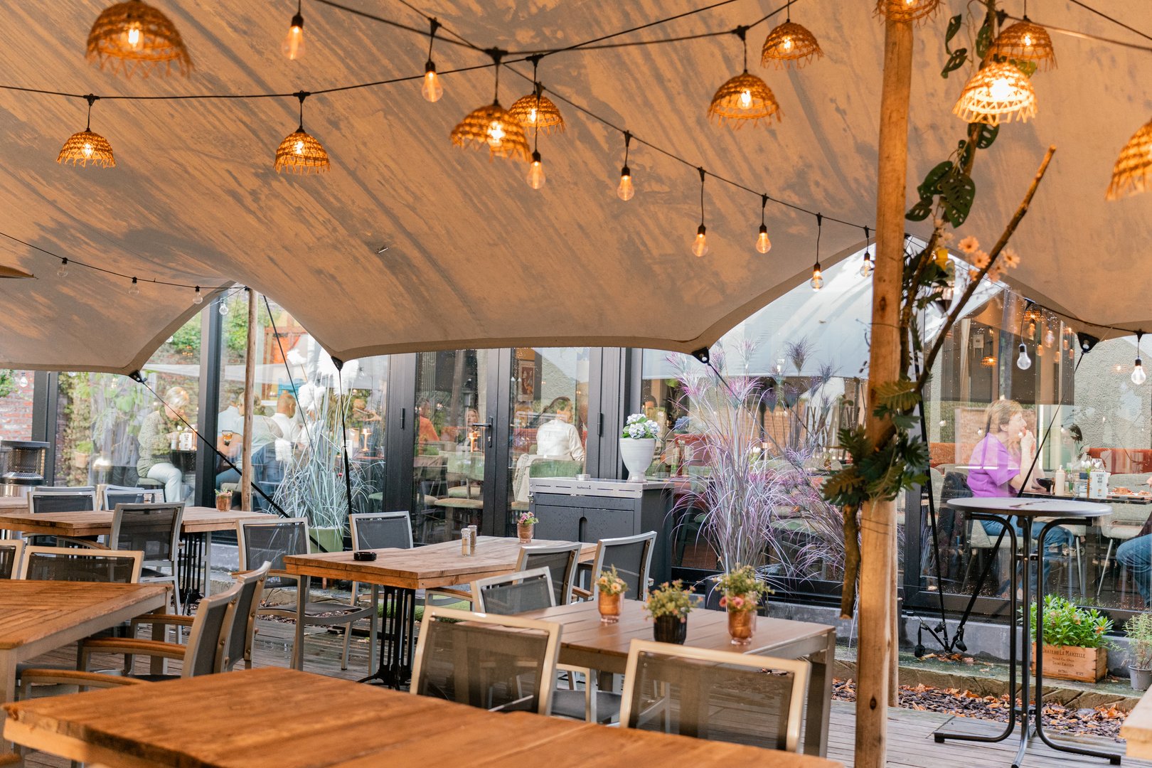 Evening outdoor dining with string lights and canopy
