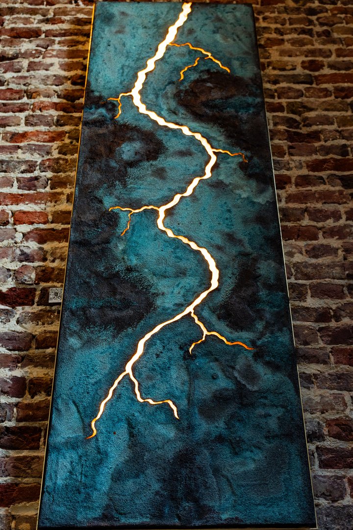 Artisan cocktail with lemon slice and ice on dark surface